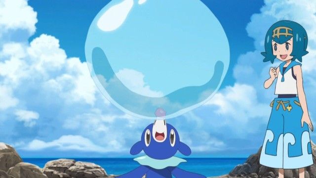 Trainer Lana teaching Popplio to blow a huge water bubble