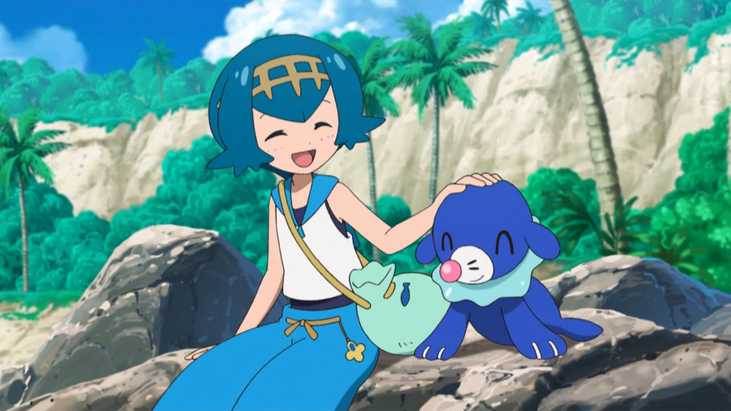Trainer Lana sitting happily with Popplio